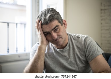 40s Or 50s Sad And Worried Man With Grey Hair Sitting At Home Couch Looking Depressed And Wasted In Sadness Face Expression In Depression And Life Problems Concept