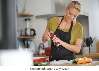 40-year-old Woman Cooking In Home Kitchen 