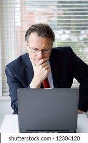 A 43 Year Old Businessman Working At His Computer.