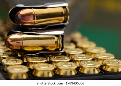 .45 ACP bullet pistol gun with green army ammo box background