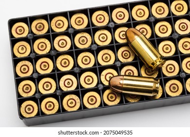 .45 ACP bullet pistol gun with ammunition box on white background