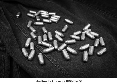 .45 ACP Cartridges On A Black Denim Background, Monochrome Photo