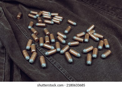 .45 ACP Cartridges On A Black Denim Background