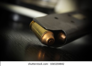 .45 caliber bullets in a magazine, slanted top view.