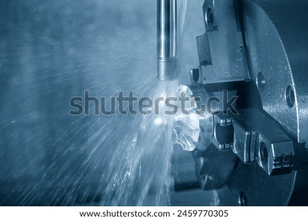 The 4-axis CNC milling machine  cutting the turbocharger part with liquid coolant method. The hi-technology automotive  parts manufacturing process by multi-axis machining center.