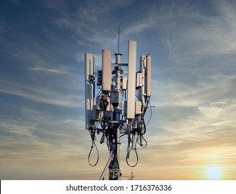 4G And 5G Cellular. Macro Base Station Or Base Transceiver Station. Telecommunication Tower. Wireless Communication Antenna Transmitter. Development Of Communication Systems In Urban Area At Sunset.