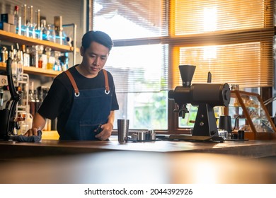 4K Asian man barista using towel sweeping counter bar with alcohol sanitizer before opening cafe. Male waiter cleaning up coffee shop for service to customer. Small business owner working concept - Powered by Shutterstock