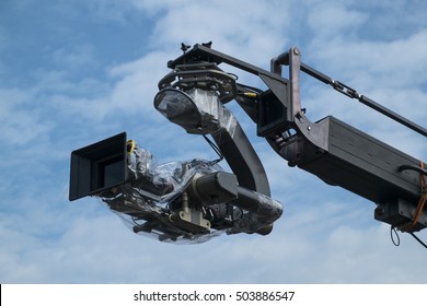 4K Cinema Production Camera With Crane In The Blue Sky. Mass Movie Industrial.