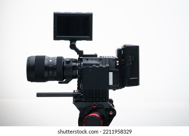 4k Digital Cinema Camera On A Tripod With A 50-100mm F1.8 Zoom Lens Compact White Background