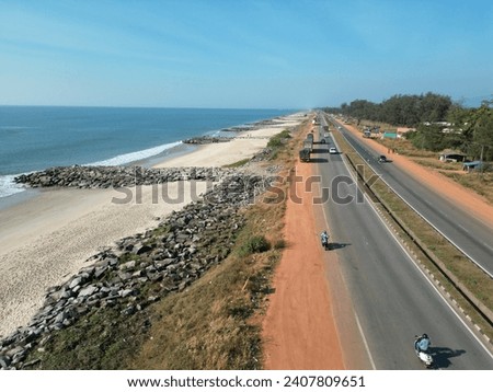 4K drone Image of Sea and the road together. Beautiful coastline with busy highway gives the relaxation stop in between the journey.