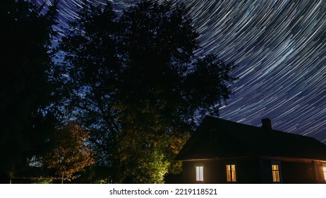 4k Hyperlapse. Dramatic Twilight Sky Spin Trails Of Stars On Night Sky Background. Stars And Meteoric Track Trails Rotate Above Rural Old Manor Countryside Landscape. Timelapse, Time Lapse, Time-lapse