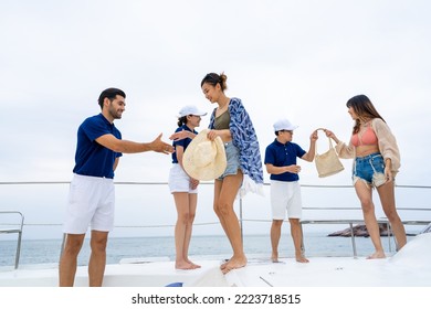 4K Man And Woman Yacht Crew In Uniform Helping Group Of Passenger Tourist Get On Luxury Private Catamaran Boat Yacht To Sailing In The Ocean On Summer Vacation. Cruise Ship Service Occupation Concept.