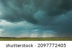 4K Sky During Rain Horizon Above Rural Wheat Landscape Field. Agricultural And Weather Forecast Concept. Storm, Thunder, thunderstorm, stormclouds, , , . Countryside Meadow In Summer Rainy Day