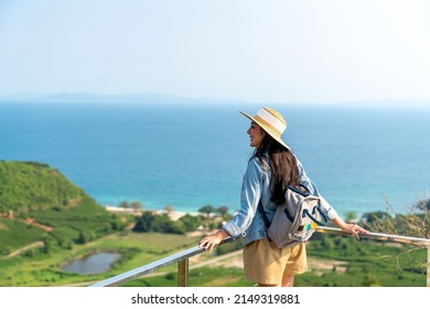4K Young beautiful Asian woman with backpack solo travel on tropical island mountain peak in summer sunny day. Cheerful female relax and enjoy outdoor lifestyle in summer beach holiday vacation trip - Shutterstock ID 2149319881