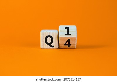 From 4th To 1st Quarter Symbol. Turned A Wooden Cube And Changed Words 'Q4' To 'Q1'. Beautiful Orange Table, Orange Background. Business, Happy 1st Quarter Q1 Concept, Copy Space.