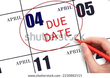 4th day of April. Hand writing text DUE DATE on calendar date April 4 and circling it. Payment due date. Business concept. Spring month, day of the year concept.