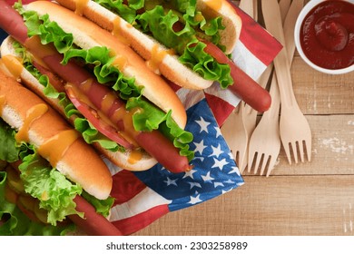 4th of July American Independence Day traditional picnic food. Hot dog with potato chips and cocktail, American flags and symbols of  USA Patriotic picnic holiday on wooden background. Top view. - Powered by Shutterstock