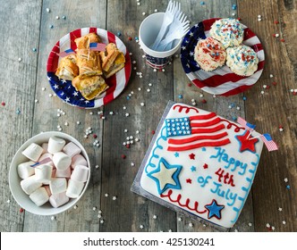 4th Of July Cake With Cupcakes, Marshmallows And Hot Dogs, Seen From Above