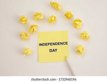 4th of July - Independence Day text on a yellow sticker or memo note with white pen and wrinkles yellow paper around. Reminder of independence day. Holidays concept. - Powered by Shutterstock