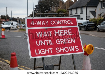 4-Way Control sign, wait here until green light shows at a junction during roadworks