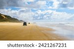 4WD trucks driving offroad on the Fraser island beach track near the SS Maheno shipwreck, half buried in the sand of the 75 mile beach on the east coast of the island in Queensland, Australia