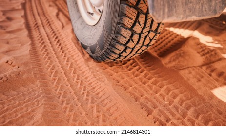 4wd Vehicle Tyre, Dirty From Dust - Track Print Visible In Red Sand, Closeup Detail