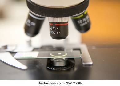 4x (scanning power) objective of a microscope above slide.
