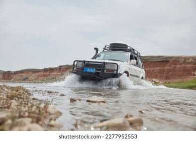 4x4 Car Crossing River At A Mountain Stream