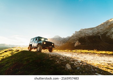 4x4 off-road car driving along a mountain track on a sunny day. car adventure trip