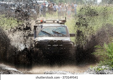 4x4 Off-road Car In A Puddle Making Mud Splashes.