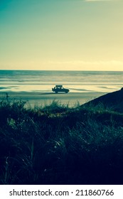 4x4 RV Van On Deserted Beach. Driving Towards The Sun, Leaving A Nice Shadow. Freedom Feeling, Cruising The Beach With A Packed Car.