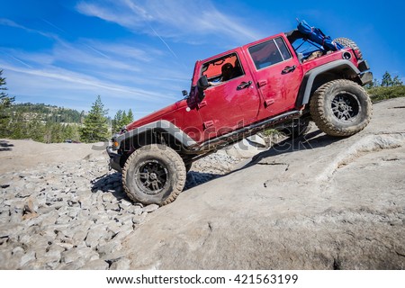 4x4 truck descending steep rock on the Rubicon Trail near Lake Tahoe, CA.