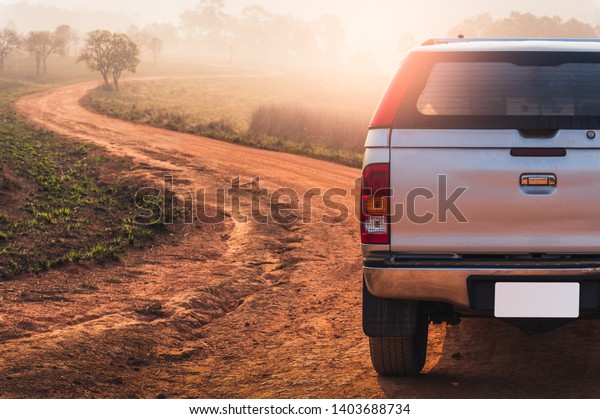 the 4x4 vehicle parking beside of the\
off-road track in the savanna field. the concept of adventure,\
travel, vihical, 4x4 and\
transportations.