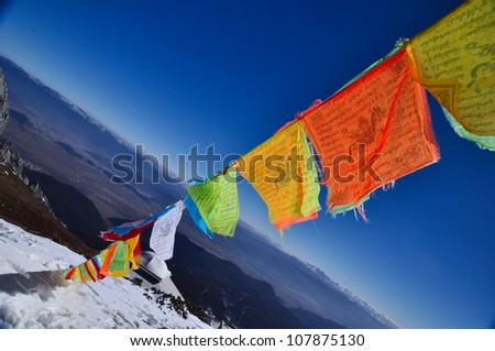 5 color flags on the top of the mountain