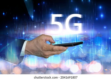 5 G Wireless High Speed Internet Access. Businessman Enters The High-speed World. Hand Holding Smart On Line Connection Network And City At Night With Global Communication.