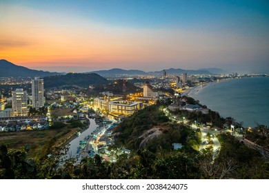 The 5 km long, curved bay of Hua Hin beach with fine and white sand, photographed from Khao Takiab Mountain in the twilight.