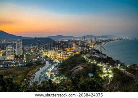 The 5 km long, curved bay of Hua Hin beach with fine and white sand, photographed from Khao Takiab Mountain in the twilight.