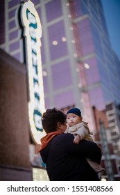 5 months asian baby boy in father's embrace in downtown Portland, Oregon