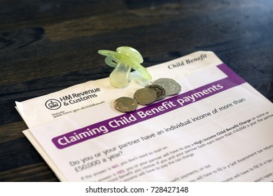 5 October 2017, Royston UK - Information Leaflets On Applying For Child Benefits, A Child's Pacifier And Some Coins (Illustrative Editorial)