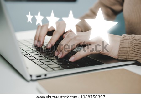 5 star rating. business woman hand working on laptop with five star button on visual screen to review good rating, digital marketing, good experience, positive thinking and customer feedback concept