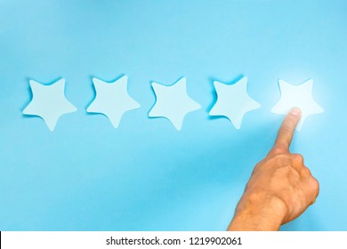 5 Star Rating. Hand Businessman Pointing Five Stars To Increase. Blue Background