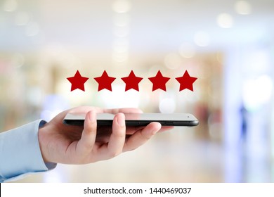 5 star review on phone, Man hand holding smartphone and red five star over blur background, customer excellent rating satisfaction, customer feedback, business concept banner