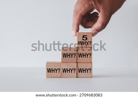 5 Whys analysis concept. Hand stacking wooden blocks with 