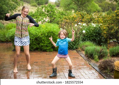 5 Year Old Boy And His 13 Year Old Sister Dancing In The Rain.