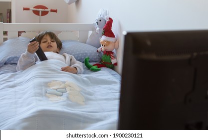 5 Year Old Boy Lying In Bed Watching Tv