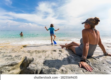 5 Year Old Boy Walking On Rock Formation With Fins, Grand Cayman Island