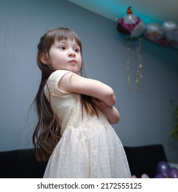 5 Year Old Girl In A Dress With A Serious Expression.