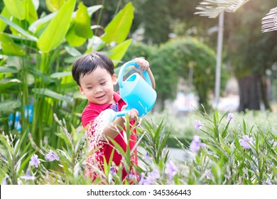 5 Years Old Asian Boy In His Flower Garden - Kids And Family. Portrait Of A Boy Working In The Garden In Holiday