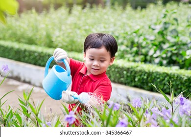 5 Years Old Asian Boy In His Flower Garden - Kids And Family. Portrait Of A Boy Working In The Garden In Holiday