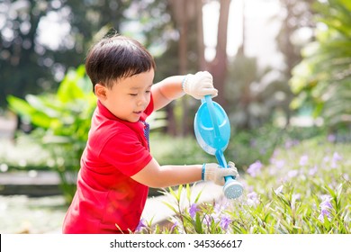 5 Years Old Asian Boy In His Flower Garden - Kids And Family. Portrait Of A Boy Working In The Garden In Holiday